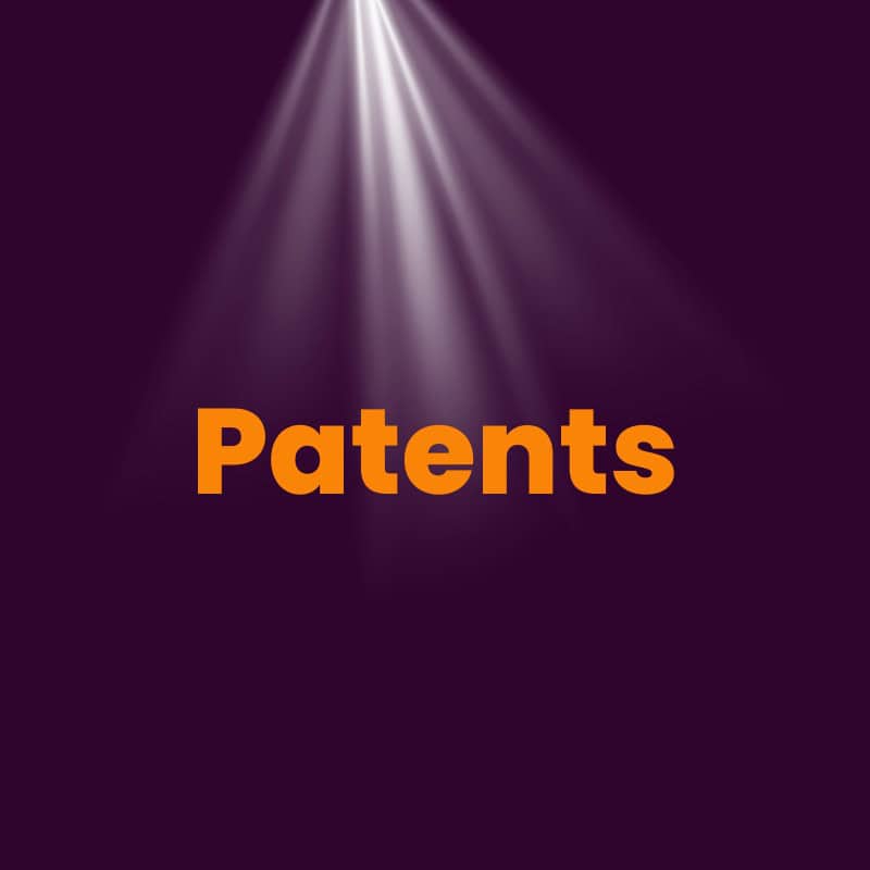 Orange text reading "patents" is illuminated by a spotlight against a dark purple background.